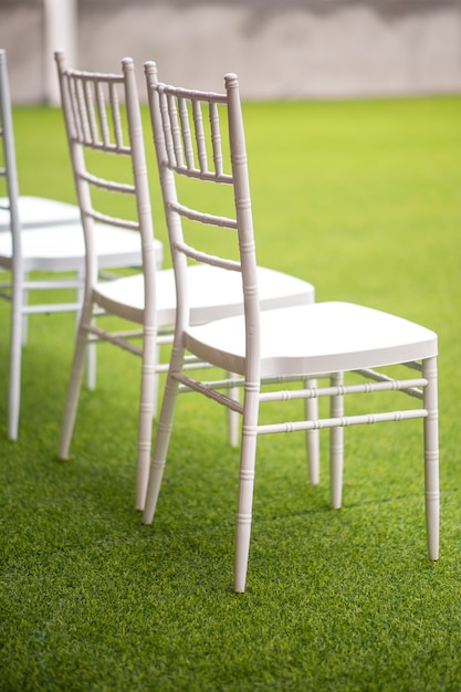 Row of white wedding chairs 