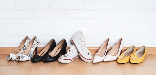 a row of womens shoes high heel shoes and comfortable sneakers among them the choice