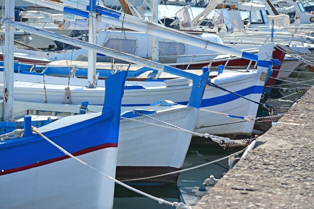 Row of wooden boats in Alghero harbor