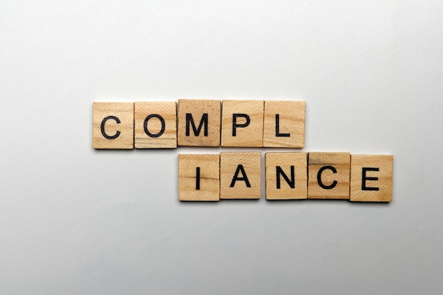 A row of wooden cubes with compliance letters