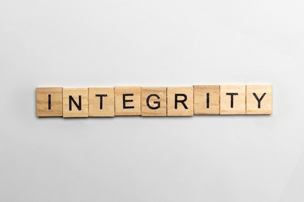 Photo the row of wooden cubes with integrity text