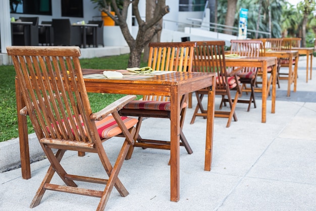 Row of wooden table with chair in the garden