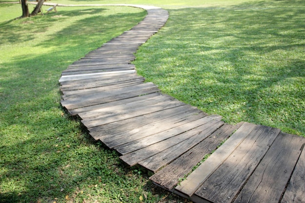 A row of wooden walkways in the garden with natural background