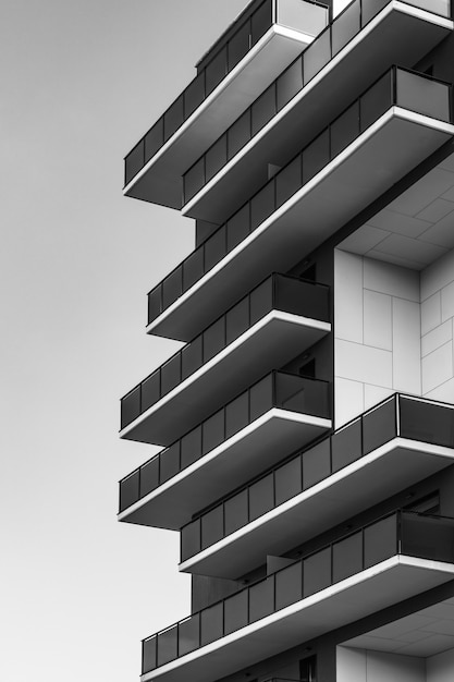 Photo rows of balconies on the corner of an urban building