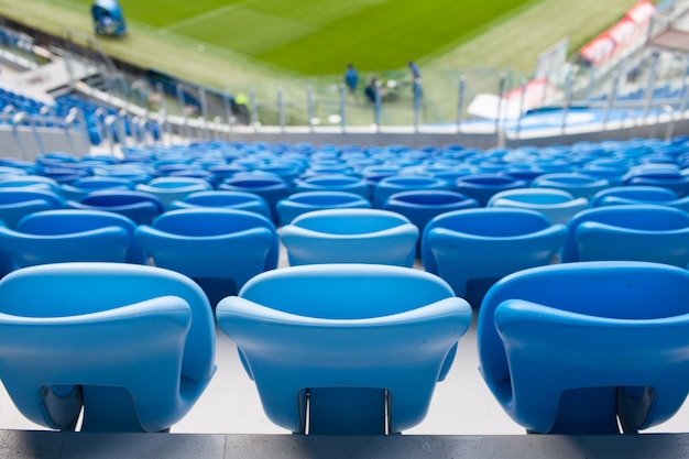 Rows of blue seats at football stadium.