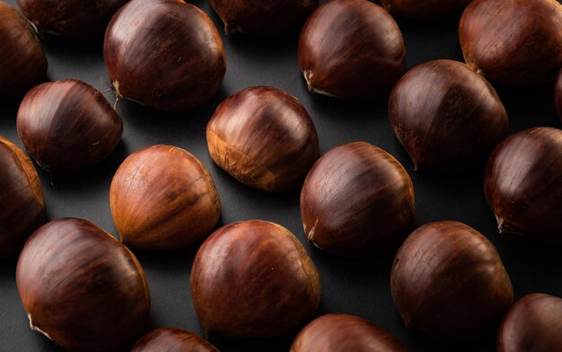 Rows of chestnuts isolated on black background