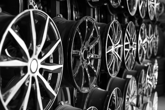 Photo rows of disks of various configurations in a shop window sale of disks and alloy wheels