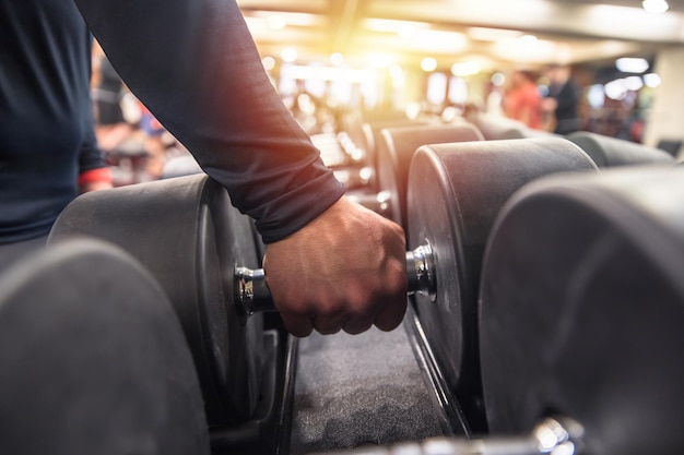 Rows of dumbbells in the gym