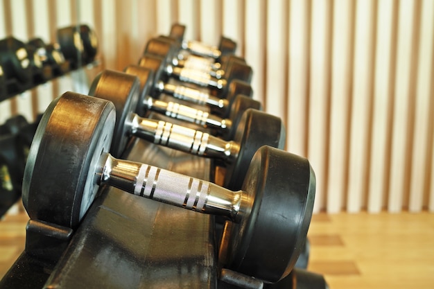 Rows of dumbbells in the gym