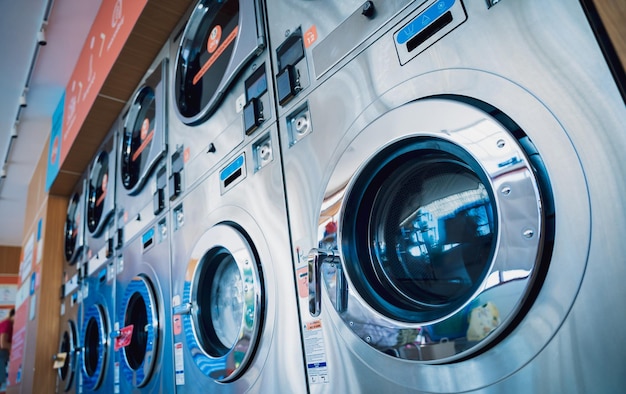 Rows of industrial laundry machines in the large laundromat