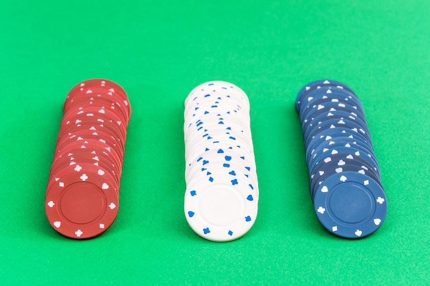 Rows of poker chips on a green background