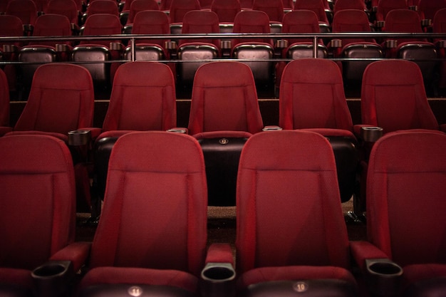 Rows of red seats in a theater with the word " the word " on the front. "