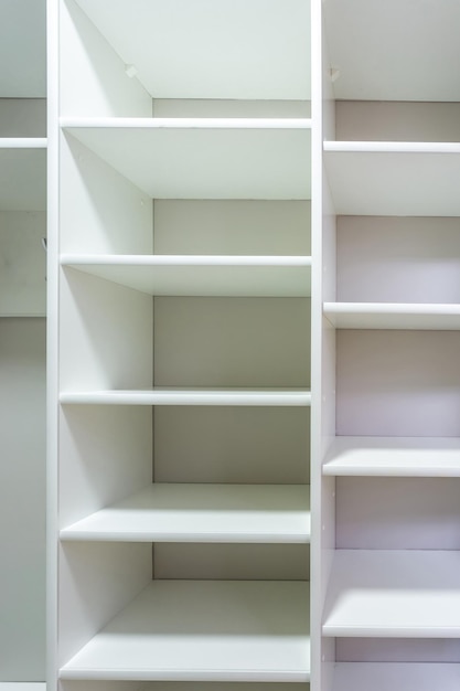 Rows of shelves and clothes hangers in the wardrobe