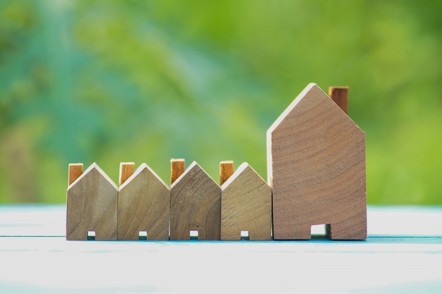 Photo rows of small wood house on natural green background