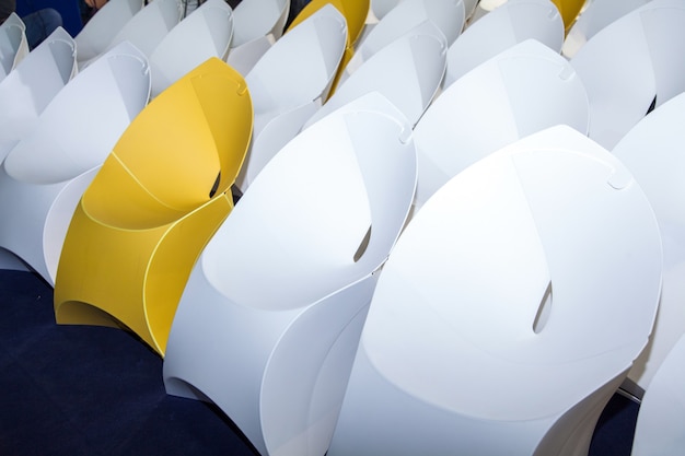 Rows of white and yellow creative paper seat place closeup