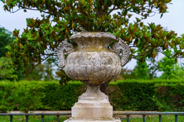 Royal palace garden with detail of ancient stone vase sculpture