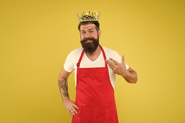 Royal recipe Man king cook wear cooking apron and golden crown Kitchen is my kingdom Ideas and tips Chief cook and professional culinary Cook food Cook with beard and mustache yellow background