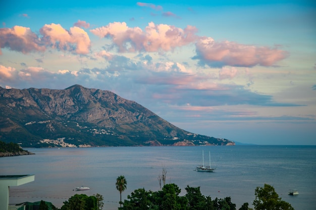 Roze berg bij zonsopganglichten in budva, montenegro