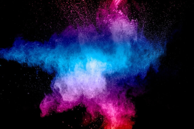 Roze blauwe stofdeeltjes spatten op zwarte achtergrond. roze blauwe poeder splash.