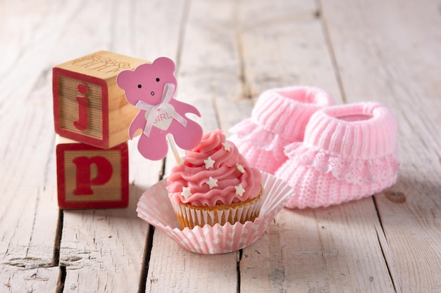 Roze cupcake voor baby shower op houten tafel