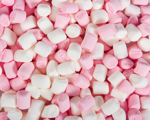 Roze en witte mini marshmallows als achtergrond Bovenaanzicht