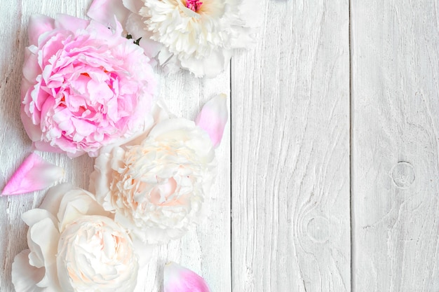 Roze en witte pioen bloemen op witte houten tafel. bovenaanzicht met kopie ruimte