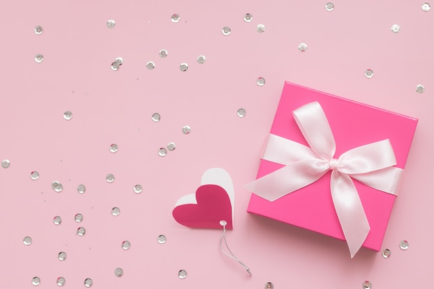 Roze geschenkdoos en confetti op roze achtergrond, Happy Valentine's Day concept