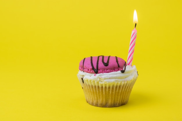 Roze kaars in bessen cupcake. Het concept van de verjaardag.