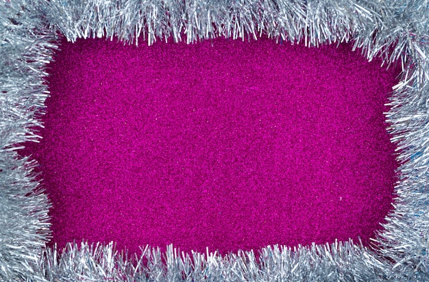 Foto roze kerst achtergrond met frame van zilver klatergoud