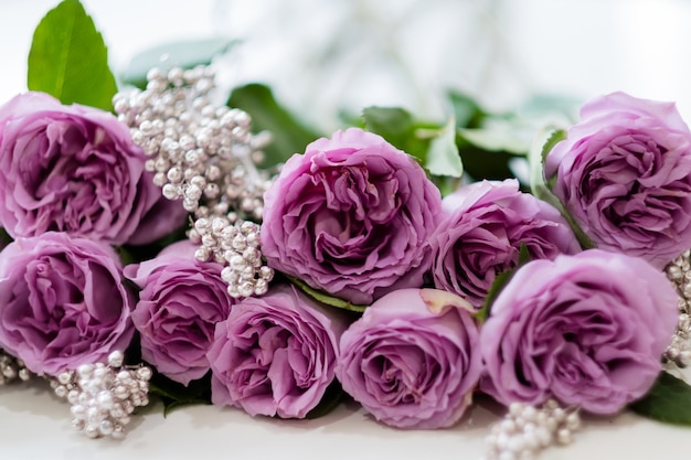 Roze rozen en zilveren decor. Mooi verjaardag bloemstuk cadeau. Eenvoudige compositie om je partner te verrassen