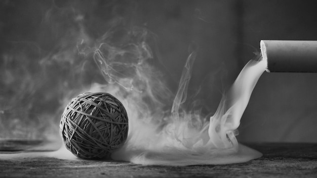 Photo rubber band ball with cigarette on field