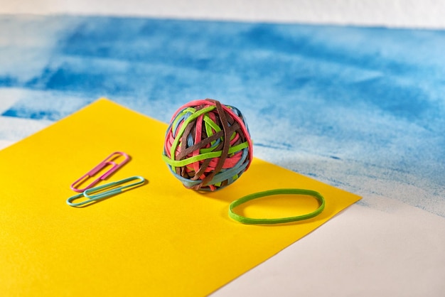 Rubber bands on yellow blue background