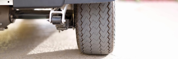 Rubber black car wheel standing on asphalt closeup