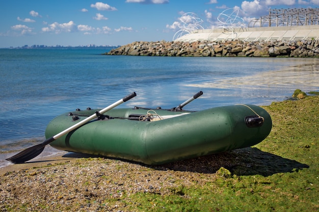 Premium Photo  Rubber boat with fishing gear standing on a river near the  sandy beach.