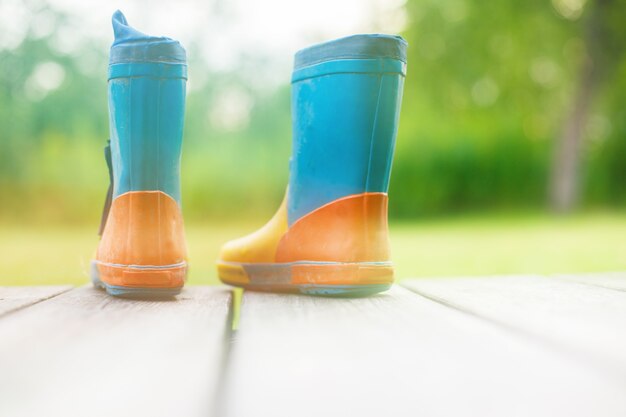 Rubber boots on a wooden background