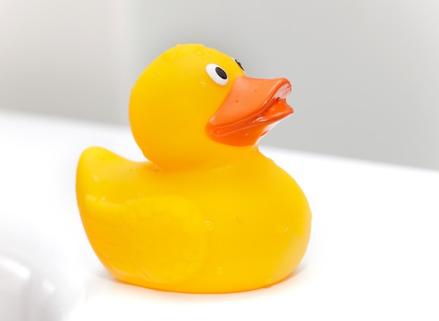 Rubber duck on the edge of the bathtub