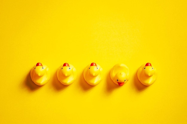 Rubber ducks on yellow Background Individuality Ideas