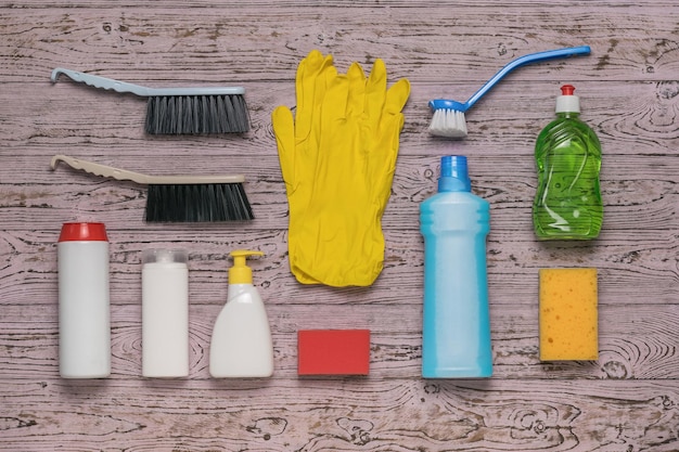 Rubber gloves and cleaning products on a wooden background Cleaning kit