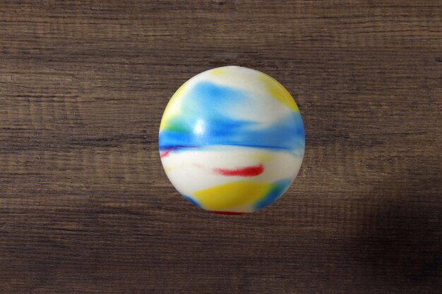 Rubber multicolor ball on a dark background