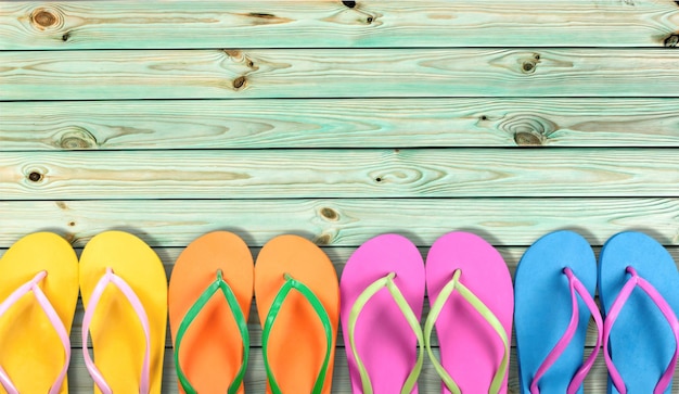 Rubber sandals flip flops on wooden background