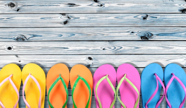 Rubber sandals flip flops on wooden background