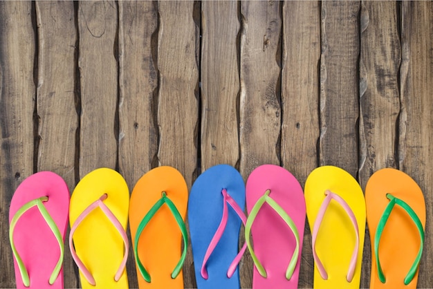 Rubber sandals flip flops on wooden background