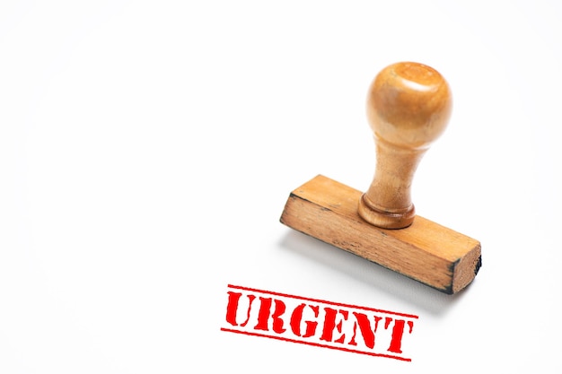 rubber stamp with urgent sign on white background. close up