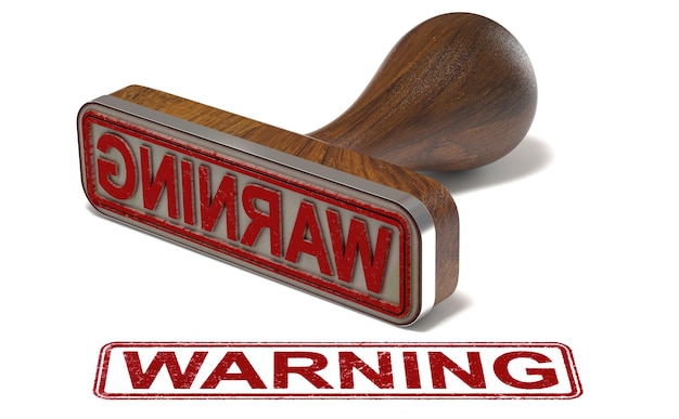 Photo rubber stamp with the word warning printed over white background