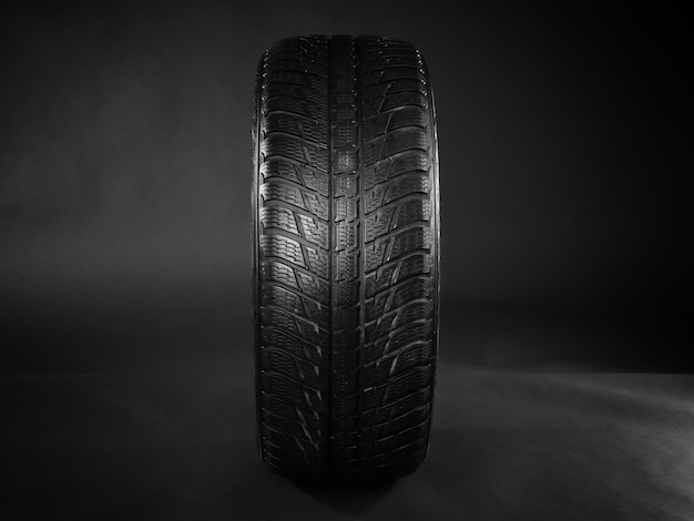 Rubber winter tire on dark background