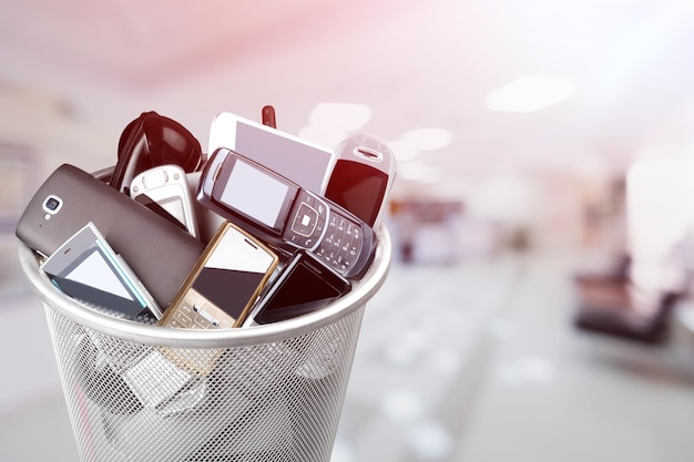 Rubbish bin full of old cellphones