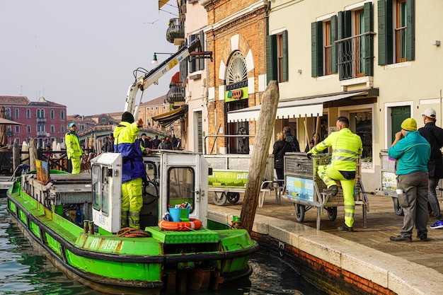 A rubbish ship stops in a canal in the Venice Lagoon