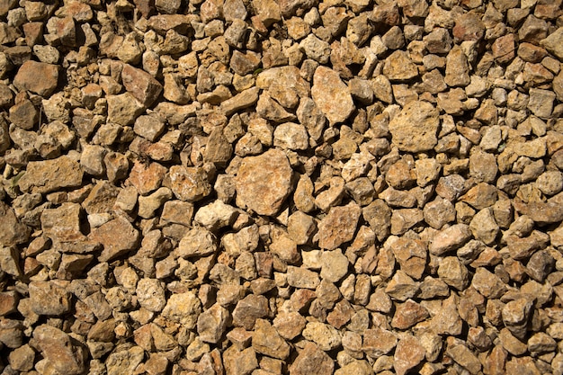 Rubble rock stone construction texture on ground.