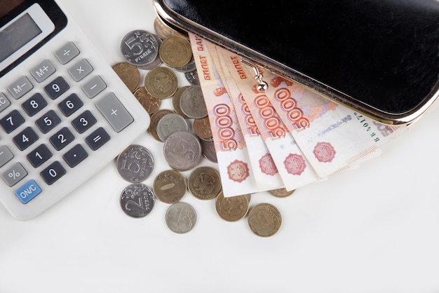 Ruble money in black purse on white background