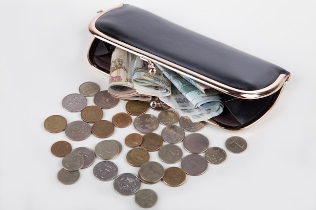 Ruble money in black purse on white background